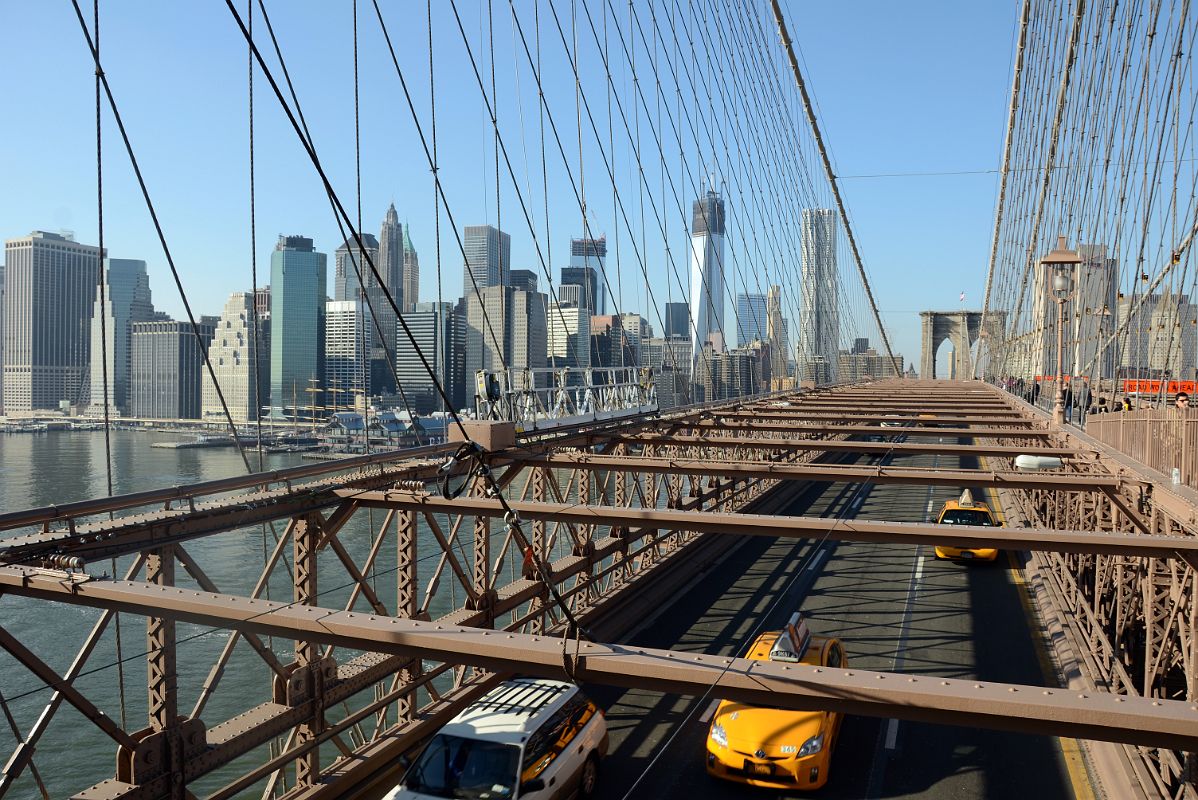 15 Cars Crossing The New York Brooklyn Bridge Under The Pedestrian Walkway With The Financial District Beyond